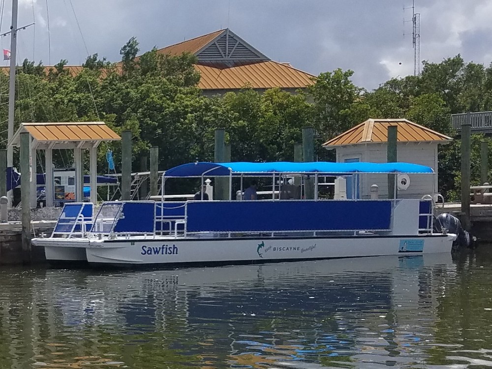 a blue and white boat parked next to a body of water