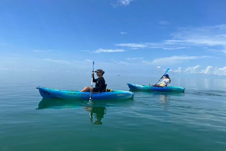 a person riding on the back of a boat in the water