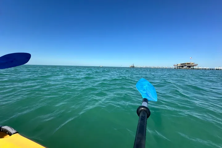 a person riding a surf board on a body of water