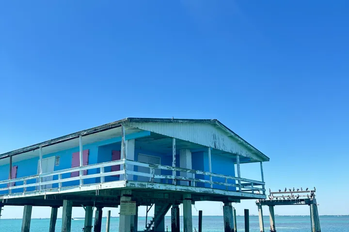 a close up of a pier next to a body of water