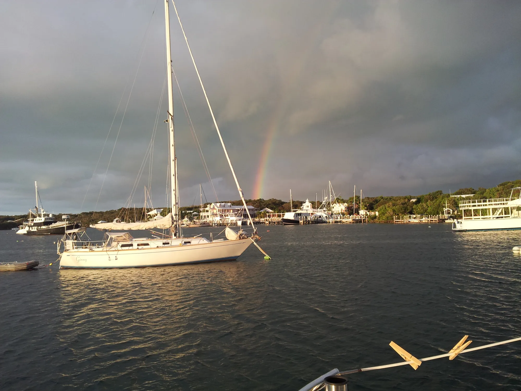 a rainbow over the park an anchored boat and a rainbow
